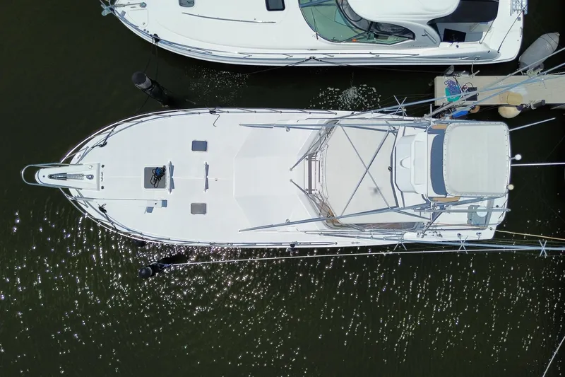 Slide: The Image of Overhead view of a 1990 Hatteras 45 Convertible yacht docked at a marina. - 85