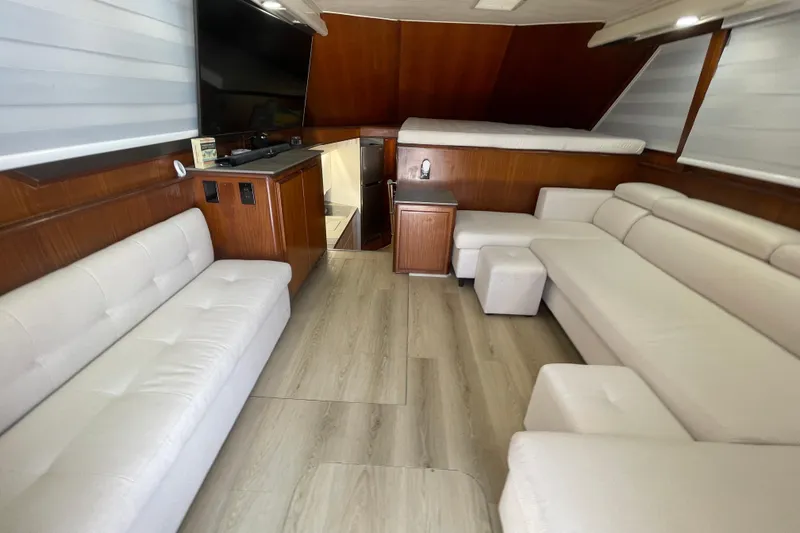 Slide: The Image of Luxurious interior of 1990 Hatteras 45 Convertible yacht with white sofas and wood accents. - 52