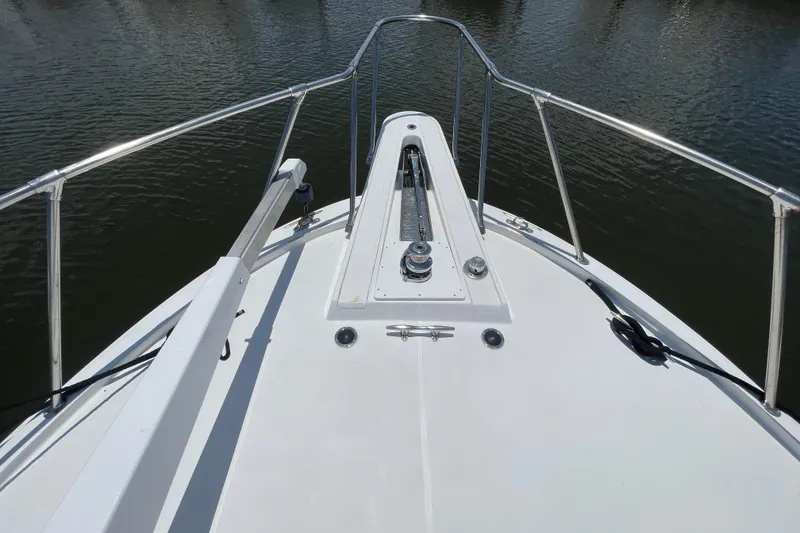 Slide: The Image of Bow view of 1990 Hatteras 45 Convertible yacht with stainless steel railings. - 44