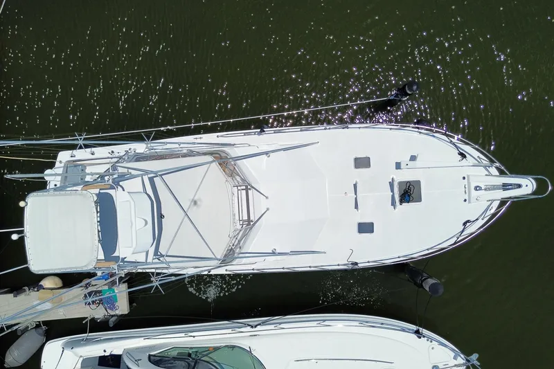 Slide: The Image of Aerial view of 1990 Hatteras 45 Convertible yacht docked on calm water. - 84