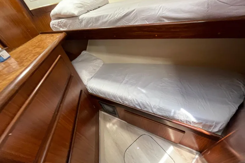 Slide: The Image of Interior of 1990 Hatteras 45 Convertible yacht with wooden bunk beds. - 72