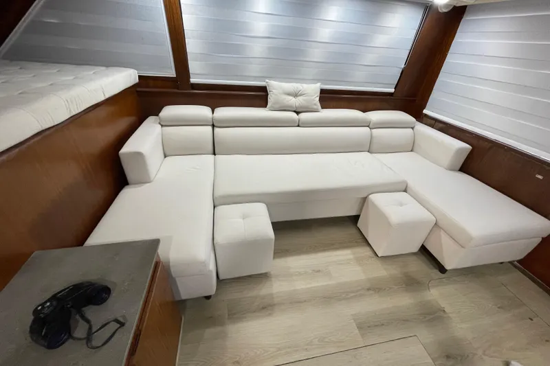Slide: The Image of Luxurious white seating area inside a 1990 Hatteras 45 Convertible yacht. - 53