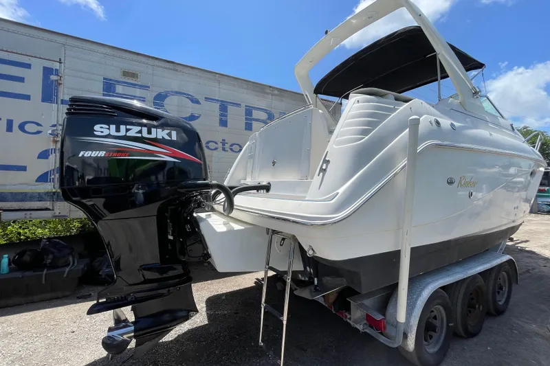 Slide: The Image of 2000 Rinker 280 Express Cruiser with Suzuki four-stroke engine on trailer. - 54