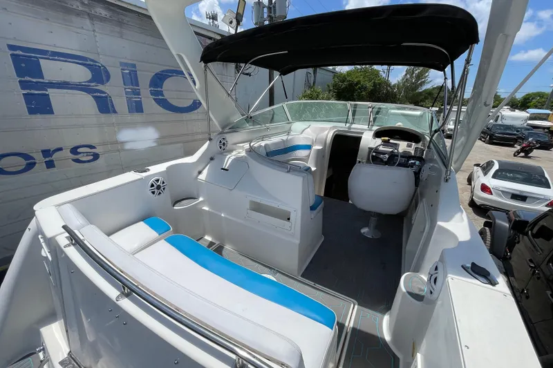 Slide: The Image of 2000 Rinker 280 Express Cruiser interior with seating, steering wheel, and canopy. - 32