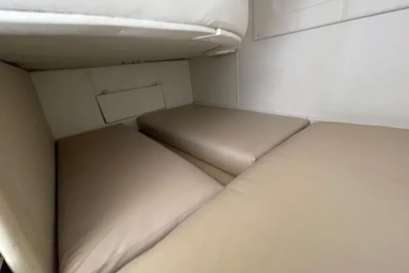 Slide: The Image of Interior cabin of 2000 Rinker 280 Express Cruiser with beige cushions. - 48
