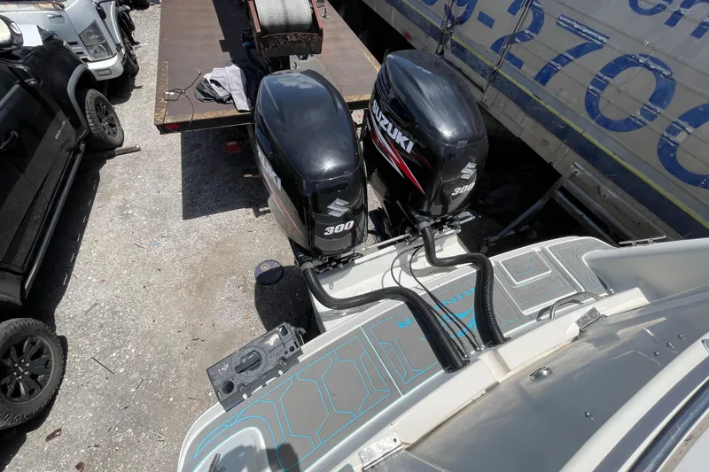 Slide: The Image of 2000 Rinker 280 Express Cruiser with dual Suzuki 300 outboard motors. - 28