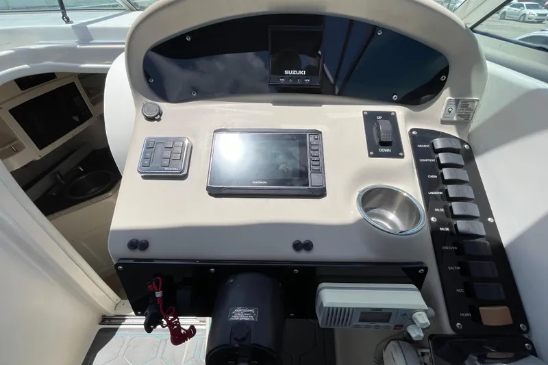Slide: The Image of Control panel of a 2000 Rinker 280 Express Cruiser with Garmin navigation system. - 36