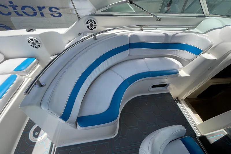 Slide: The Image of Interior seating of a 2000 Rinker 280 Express Cruiser with blue and white upholstery. - 35