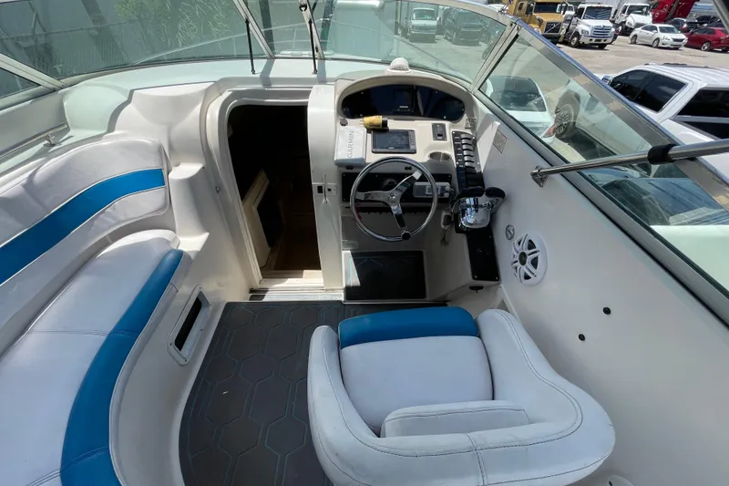 Slide: The Image of 2000 Rinker 280 Express Cruiser cockpit with steering wheel and seating. - 37