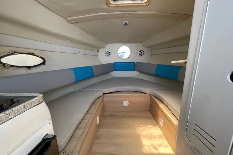 Slide: The Image of Interior of a 2000 Rinker 280 Express Cruiser, featuring cozy seating and modern design. - 43