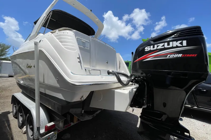 Slide: The Image of 2000 Rinker 280 Express Cruiser with Suzuki four-stroke engine on trailer. - 53