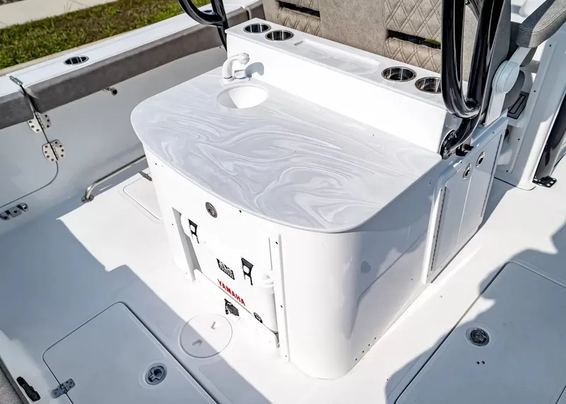 Slide: The Image of The image shows the cockpit of a Sea Hunt Ultra 285 SE boat with a sleek countertop. - 9