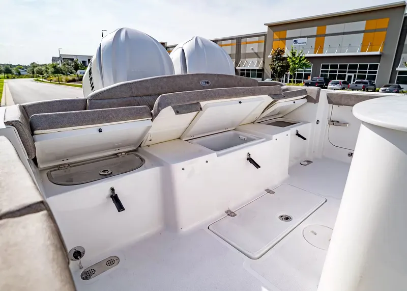 Slide: The Image of The image shows the stern of a Sea Hunt Ultra 285 SE boat with storage and engines. - 10