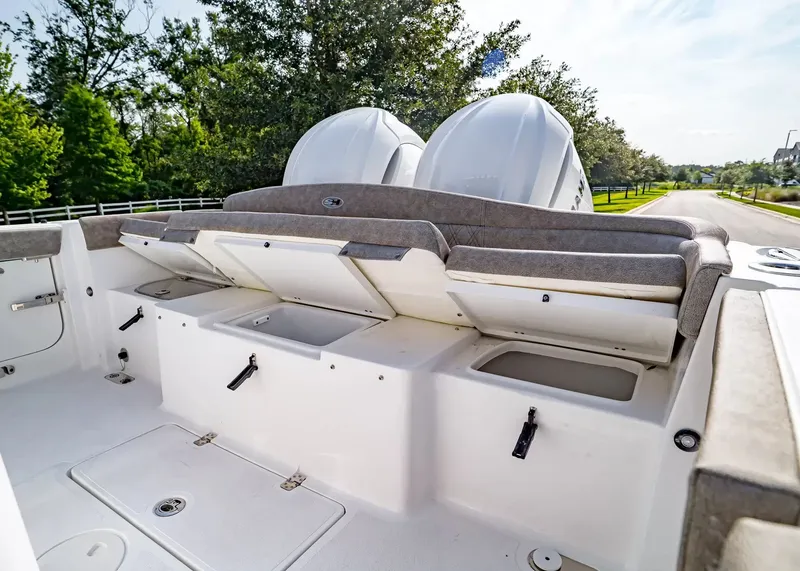 Slide: The Image of The image shows the stern of a Sea Hunt Ultra 285 SE boat with storage and two engines. - 11