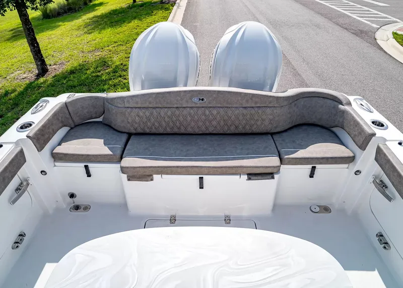 Slide: The Image of The image shows the stern of a Sea Hunt Ultra 285 SE boat with gray cushions. - 4