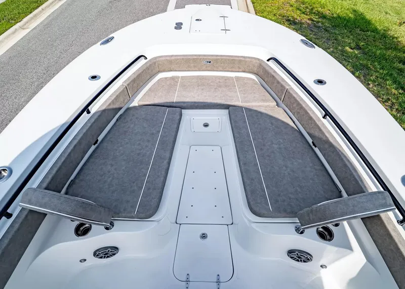 Slide: The Image of The image shows the bow of a Sea Hunt Ultra 285 SE boat. It features cushioned seating areas and speakers. - 26
