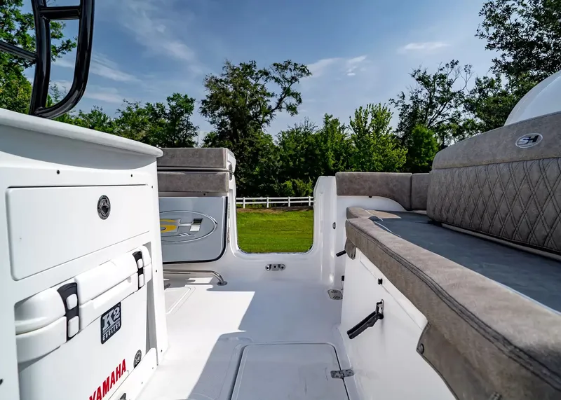 Slide: The Image of Interior of a Sea Hunt Ultra 285 SE boat with gray upholstery and a Yamaha cooler. - 13