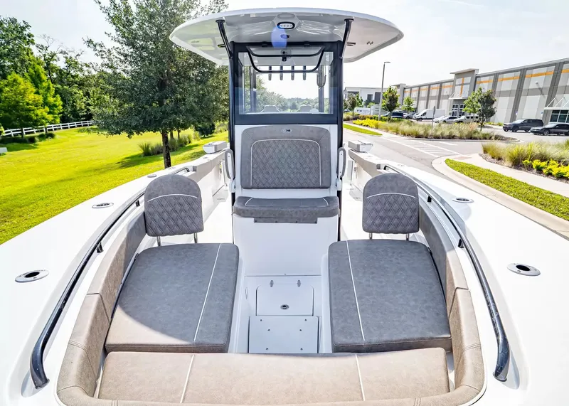 Slide: The Image of The image shows the deck of a 2027 Sea Hunt Ultra 285 SE boat with gray upholstery. - 23