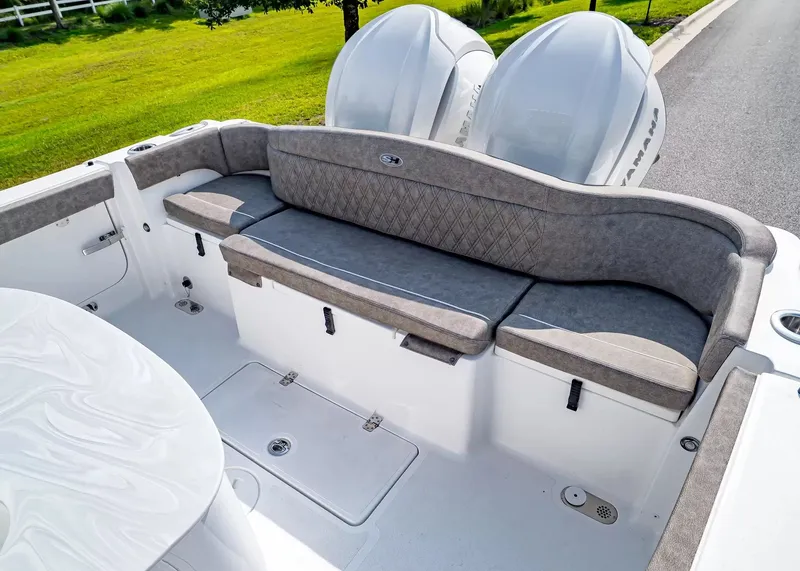 Slide: The Image of The image shows the cockpit of a Sea Hunt Ultra 285 SE boat with gray upholstery. - 5