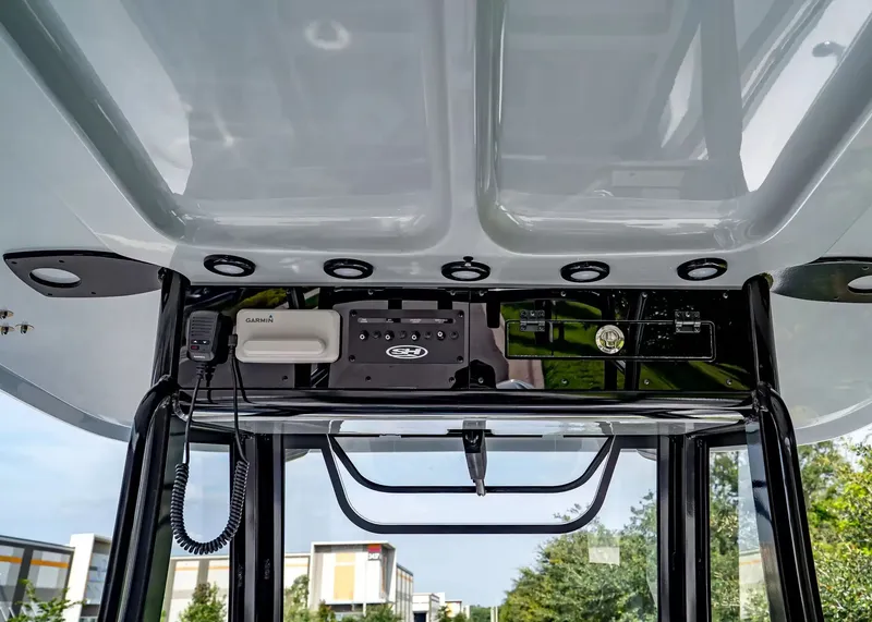 Slide: The Image of The image shows the helm of a Sea Hunt Ultra 285 SE boat with modern electronics. - 16