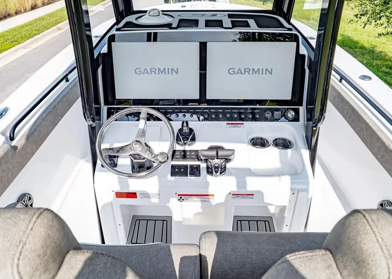 Slide: The Image of The cockpit of the Sea Hunt Ultra 285 SE features two large Garmin screens and a sleek steering wheel. - 17