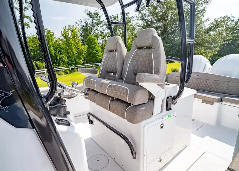Slide: The Image of Two cushioned seats on a boat with a white deck and black frame. - 19