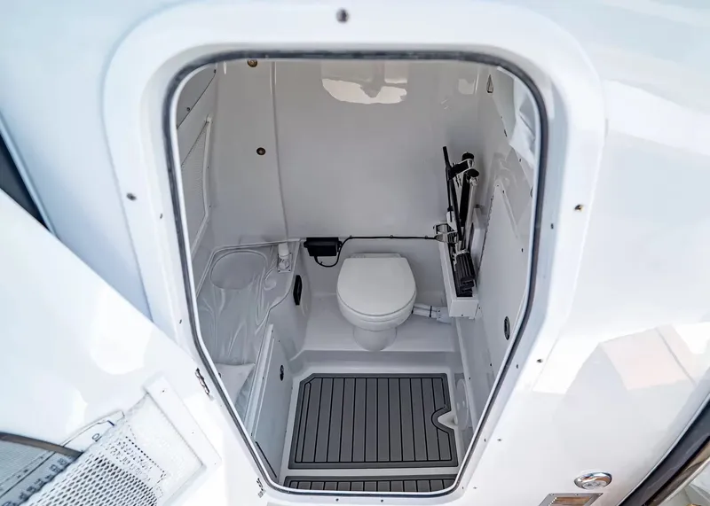 Slide: The Image of Interior view of a boat toilet with white interior and gray flooring. - 20