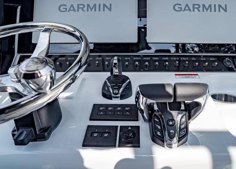 Slide: The Image of Close-up of a Sea Hunt Ultra 285 SE helm with Garmin screens and control levers. - 18