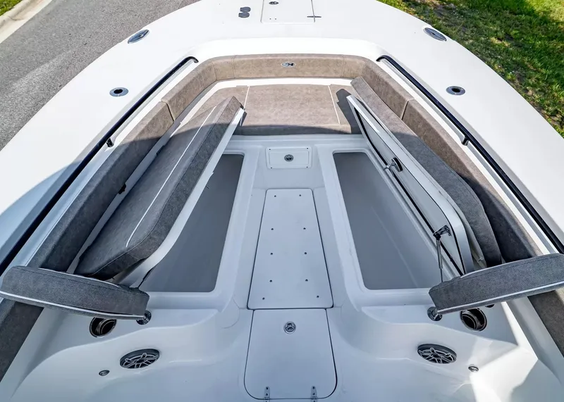 Slide: The Image of Bow area of the Sea Hunt Ultra 285 SE with cushioned seating and storage compartments. - 25