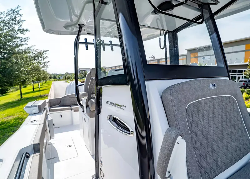 Slide: The Image of The image shows the cockpit of a 2027 Sea Hunt Ultra 285 SE boat. - 21
