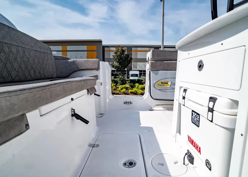 Slide: The Image of Interior view of a Sea Hunt Ultra 285 SE boat with gray seating and white flooring. - 14
