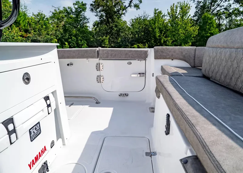 Slide: The Image of The image shows the cockpit of a Sea Hunt Ultra 285 SE boat with gray upholstery. - 6