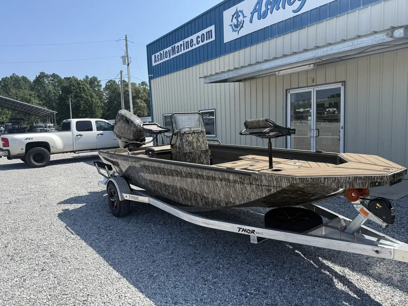 Slide: The Image of A 2027 Thor LAKE HAMMER 1900 CC boat on a trailer in front of a building. - 2