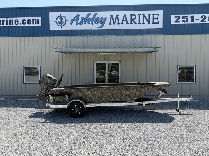 The Image of A 2027 Thor Fish Hammer boat on a trailer in front of a building. - 1