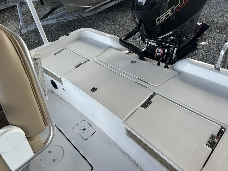 Slide: The Image of The image shows the deck of a Blazer 2200 PURE BAY boat with an outboard motor. - 12