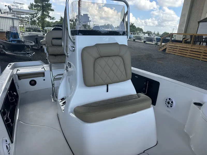 Slide: The Image of The image shows the cockpit of a Blazer 2200 PURE BAY boat with cushioned seating. - 8