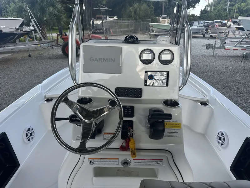 Slide: The Image of The image shows the helm of a Blazer 2200 PURE BAY boat with Garmin equipment. - 13