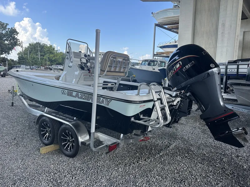 Slide: The Image of A Blazer 2200 PURE BAY boat on a trailer, featuring a Yamaha outboard motor. - 7