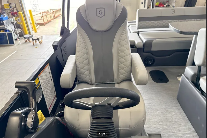 Slide: The Image of Captain's chair in 2027 Godfrey Monaco 25' Tritoon, featuring luxurious gray upholstery. - 35