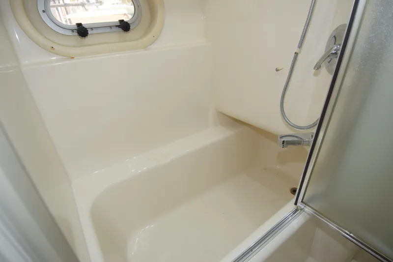 Slide: The Image of Bathroom shower area in 1999 Bayliner 5288 Pilot House Motoryacht, featuring a compact design. - 9