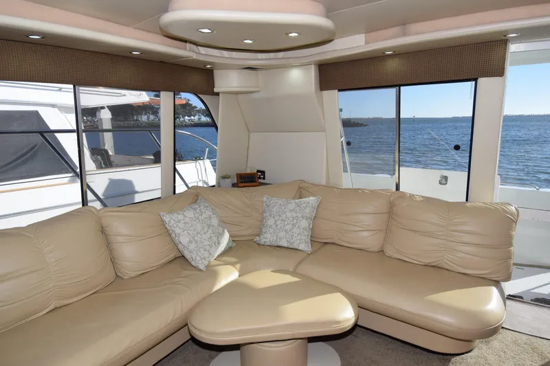Slide: The Image of Luxurious interior of 1999 Bayliner 5288 Pilot House Motoryacht with beige leather seating and ocean view. - 3
