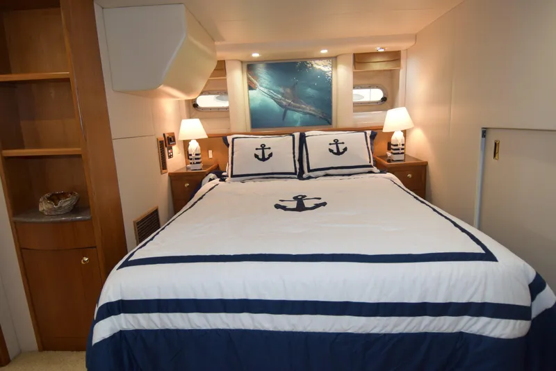 Slide: The Image of Luxurious bedroom in 1999 Bayliner 5288 Pilot House Motoryacht with nautical-themed bedding. - 7