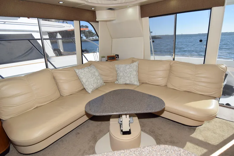 Slide: The Image of Luxurious interior of 1999 Bayliner 5288 Pilot House Motoryacht with beige leather seating and ocean view. - 2