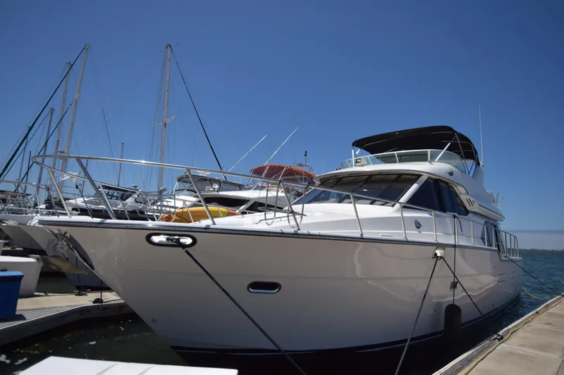 Slide: The Image of 1999 Bayliner 5288 Pilot House Motoryacht docked at marina under clear blue sky. - 14