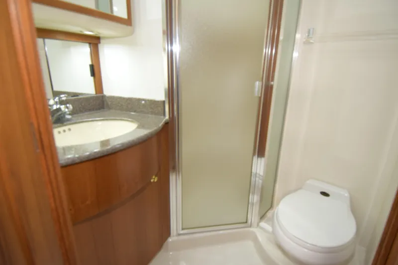 Slide: The Image of Bathroom interior of 1999 Bayliner 5288 Pilot House Motoryacht with shower, sink, and toilet. - 11