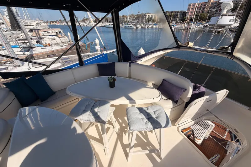 Slide: The Image of Luxurious 2001 Fairline 55 yacht interior with marina view, featuring elegant seating and table. - 61