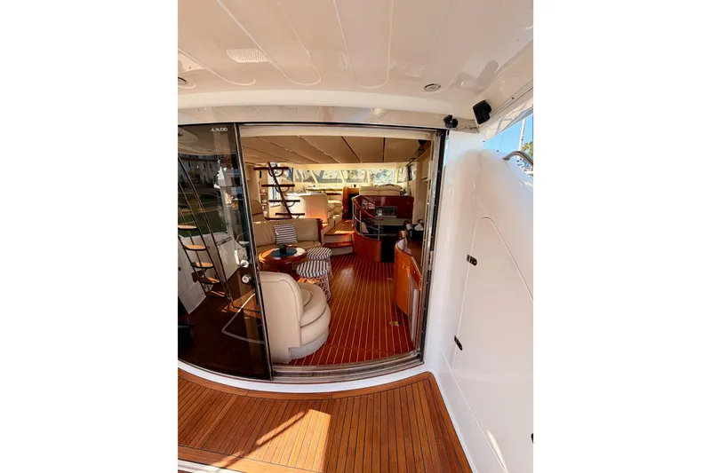 Slide: The Image of Interior view of a 2001 Fairline 55 yacht, featuring elegant wood flooring and luxurious seating. - 20
