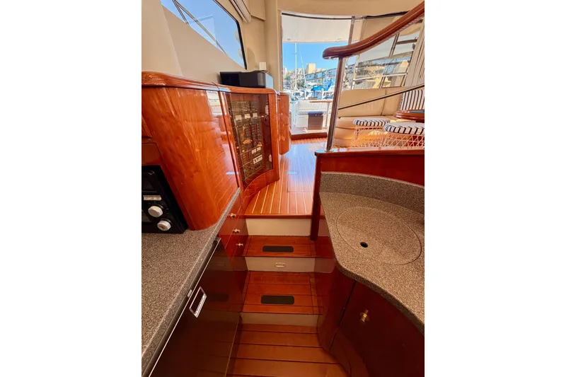 Slide: The Image of Luxurious interior of a 2001 Fairline 55 yacht, featuring polished wood and modern amenities. - 42