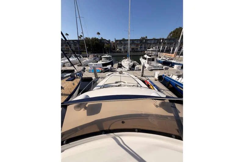 Slide: The Image of 2001 Fairline 55 yacht docked at a marina, surrounded by other boats. - 75
