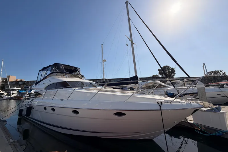 Slide: The Image of 2001 Fairline 55 yacht docked at marina under clear blue sky. - 2